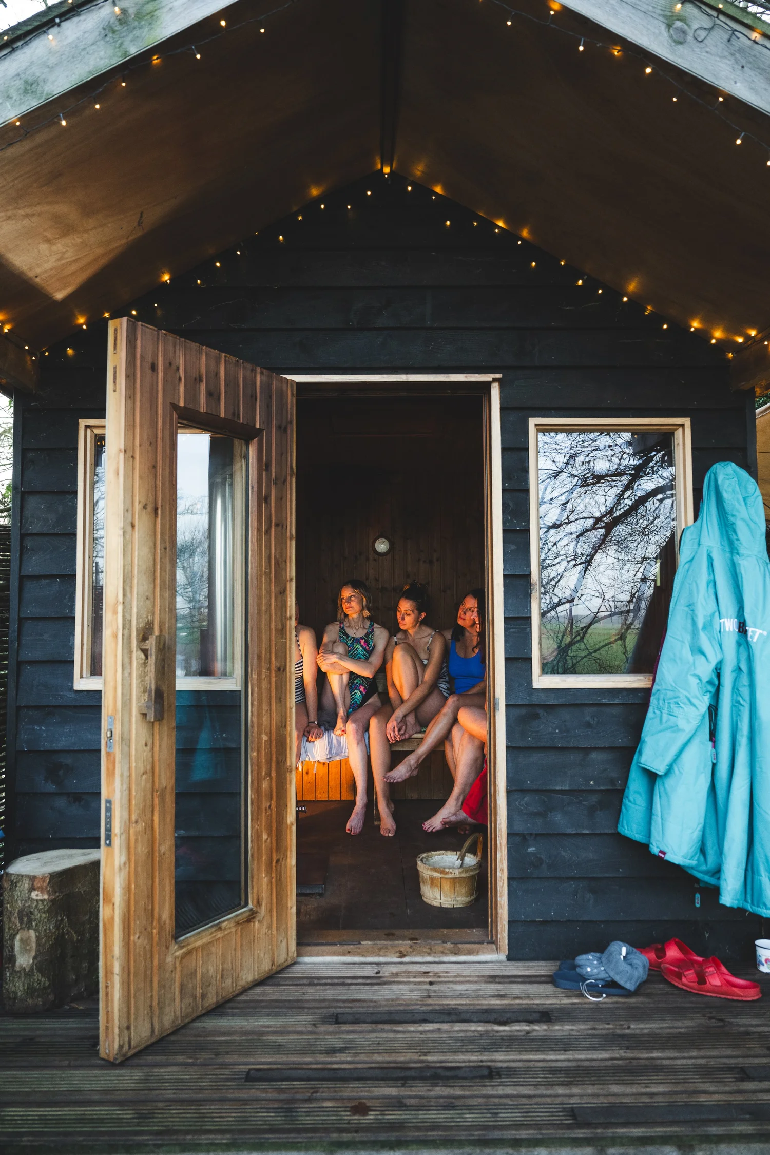 Guests relaxing at the Secret Sauna riverside retreat